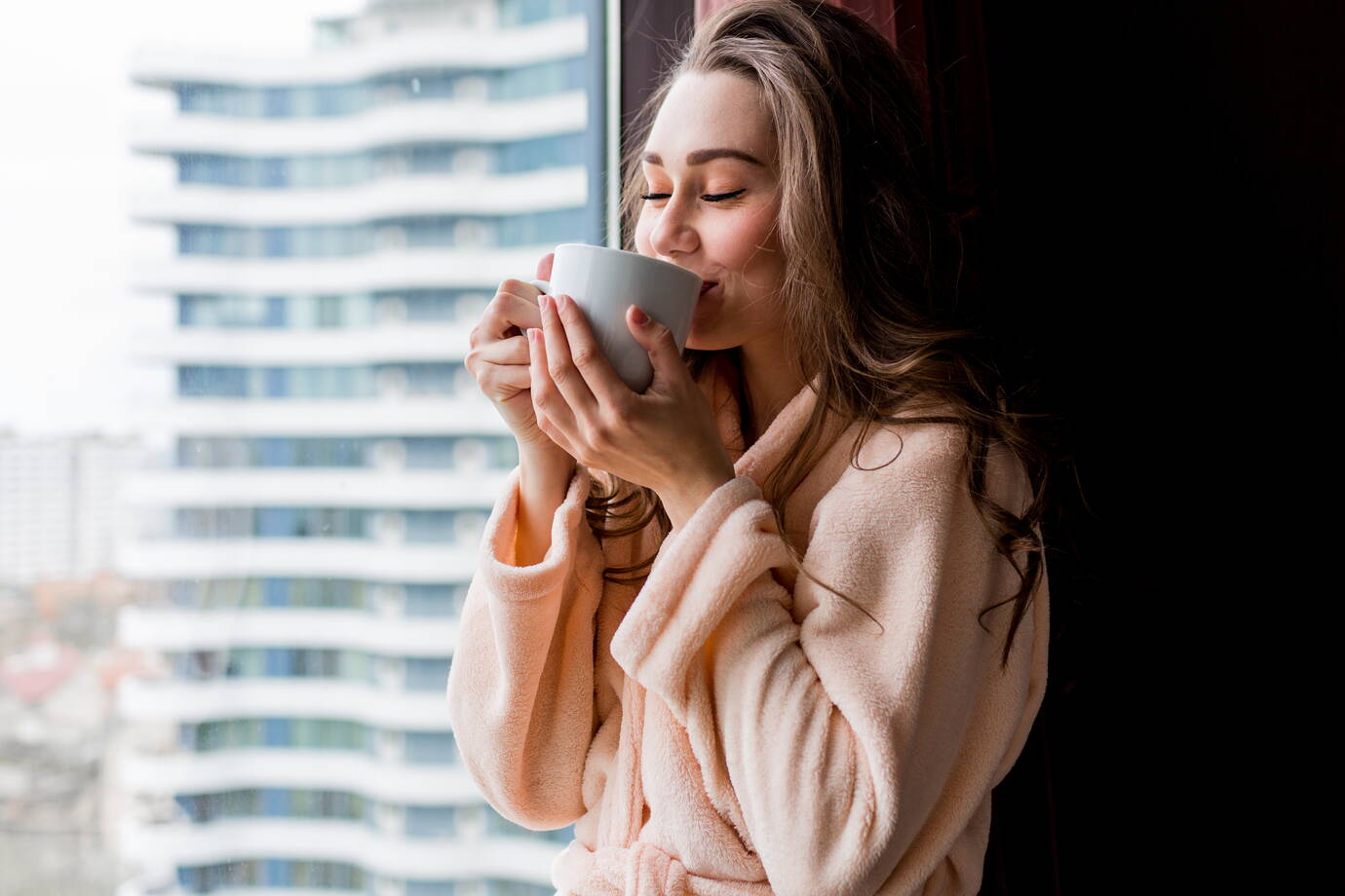 fresh-young-woman-pink-tender-bathrobe-drink-tea-looking-out-window.jpg